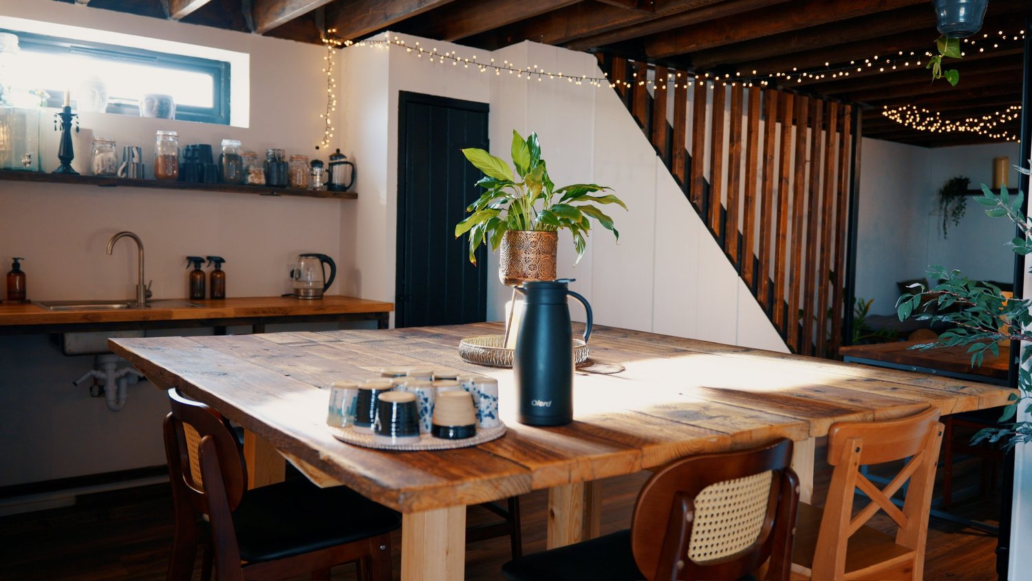 The long wooden table and kitchen at The Space